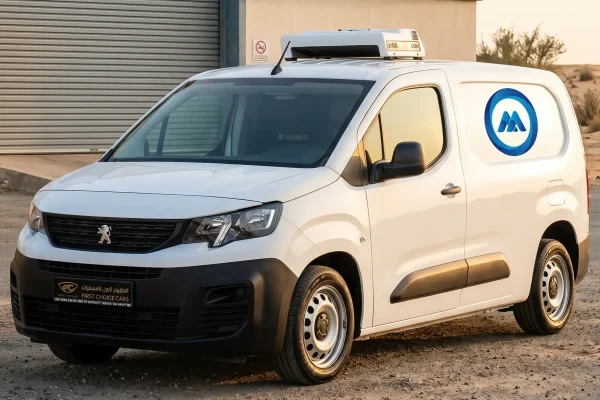 Freezer van parked outside Al Ain Industrial Area facility with refrigeration unit running, ADAFSA certified vehicle